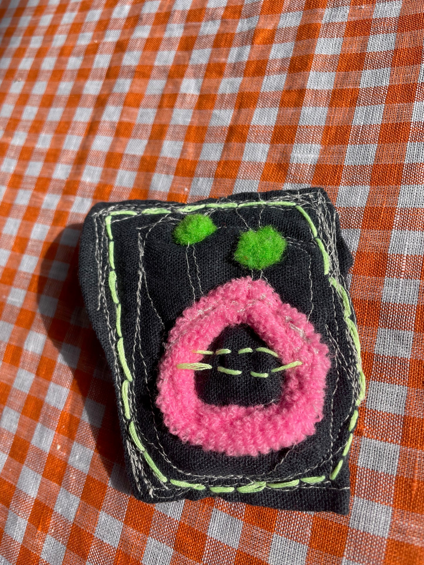 shocked creature w/ tree-frog-colored eyes / a brooch / one-of-a-kind